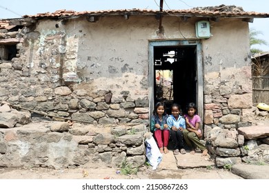 BELGAUM, INDIA - Apr 07, 2022: A Selective Focus Of A South Indian Village Kid In Front Of A Village House 