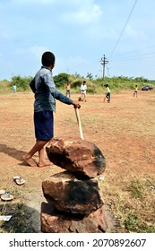 Belgaum, Karnataka, India - Nov 7, 2021: A Young Indian Village Boy Is Batting During A Gully Cricket Game.