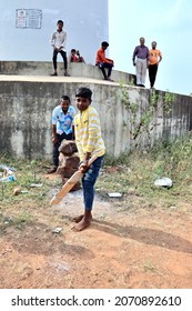 Belgaum, Karnataka, India - Nov 7, 2021: A Young Indian Village Boy Is Batting During A Gully Cricket Game.