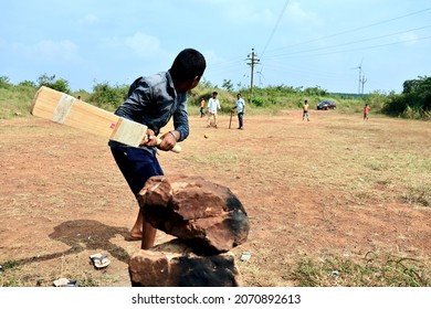 Belgaum, Karnataka, India - Nov 7, 2021: A Young Indian Village Boy Is Batting During A Gully Cricket Game.