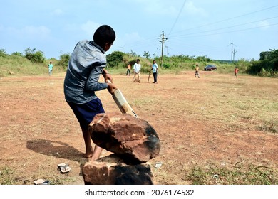 Belgaum, Karnataka, India - Nov 7, 2021: A Young Indian Village Boy Is Batting During A Gully Cricket Game.