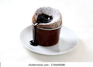 Belgian Chocolate Souffle Flowing On A White Plate