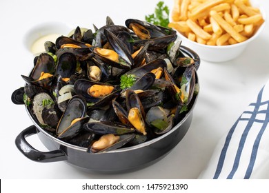 Belgian Mussels And Fries On White Marble 