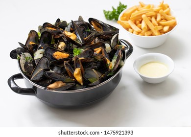 Belgian Mussels And Fries On White Marble 