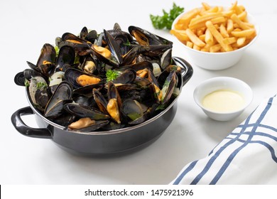 Belgian Mussels And Fries On White Marble 