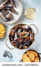 Belgian Mussels With Toasted Bread And White Wine, Overhead Flat Lay Shot On A Slate Background