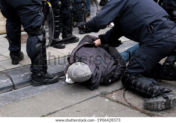 Belgian Police officers arrest protestors during an\
unauthorized demonstration against measures taken in order to stem\
the spread of the Covid-19 pandemic in Brussels, Belgium on January\
31, 2021.