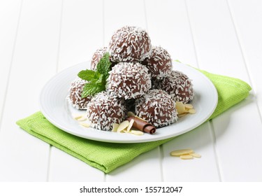 belgian pralines sprinkled with coconut, on a plate with linen