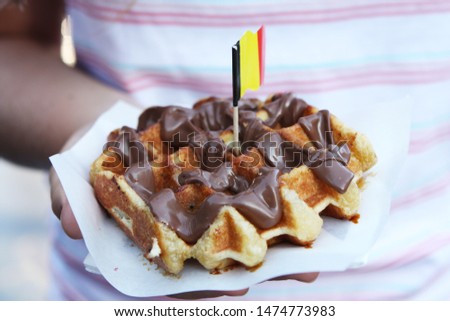 Belgian waffle with chocolate sauce.