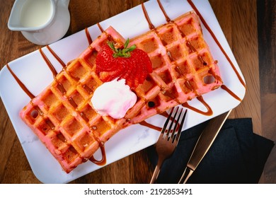 Belgian Waffle With Dulce De Leche, Carmel Drizzle And Strawberry Garnish.