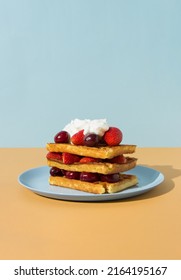 Belgian Waffle With Strawberries, Cherries And Whipped Cream Above. Sharp Shadows.