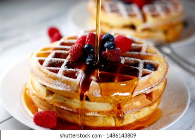 Belgian Waffles for breakfast or brunch with fresh blueberries and raspberry, healthy breakfast, stack of waffles