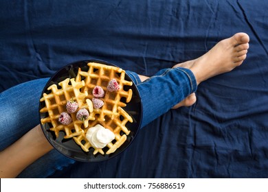 Belgian Waffles With Cream And Frozen Raspberries On Blue Ceramic Plate In Woman' S Hands. Top View