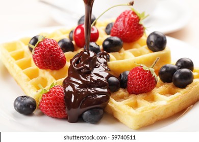 Belgian Waffles With Strawberry, Cherry, Blueberry, And Chocolate Sauce