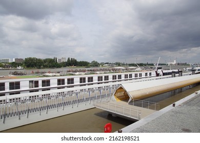 Belgium, Antwerp, May 26, 2022. Cruise terminal with yellow pontoon for mooring river and sea cuise ships. River Scheldt (Schelde) in the Belgian city of Antwerp. Spring, May.