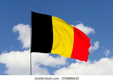 Belgium flag isolated on the blue sky with clipping path. close up waving flag of Belgium. flag symbols of Belgium.