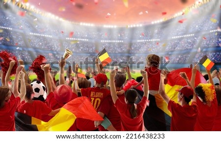 Belgium football fan on stadium. Belgian supporters watch soccer on outdoor field. Cheering team fans celebrate victory. Go Red Devils! Supporter in national jersey with country flag. Win celebration.