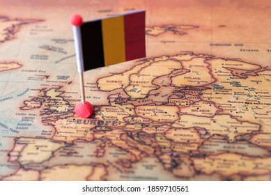 Belgium marked with a flag on the map. Flag of Belgium on the world map. The concept of travel and tourism.