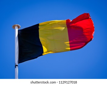 Belgium National Flag blowing in the wind showing tricolour.