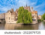 Belgium - September 21, 2024: Belgium, West Flanders (Vlaanderen), Bruges (Brugge). Belfort van Brugge and medieval buildings on the Dijver canal from Rozenhoedkaai at dawn.