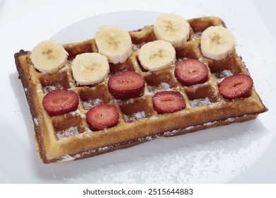 Belgium waffle with banana and strawberries slices on white plate  - Powered by Shutterstock