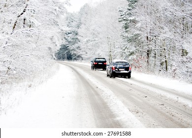 Belgium In Winter, Cars Driving Over A Snow Covered Street