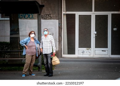 BELGRADE, JUNE 3, 2021: Selective Blur On Old Senior Man And Woman, Couple, Wearing A Facemask, Standing In Street Of Belgrade With Grocery Bags In Summer During  Coronavirus Covid 19 Health Crisis.

