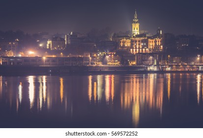 Belgrade At Night From The River Sava. View On The Centar Of City Belgrade And Saborna Church By Night. Haze Effect