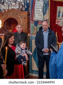 Belgrade, Serbia, 31 Oct 2021: Orthodox Church of Holy Trinity. Baptism of a child. Mother is holding a child. Accepting religion