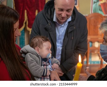 Belgrade, Serbia, 31 Oct 2021: Orthodox Church of Holy Trinity. Baptism of a child. Mother is holding a child. 