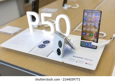 Belgrade, Serbia - April 04, 2022: New Huawei P50 Pro mobile smartphone and P50 Pocket folded mobile phone are shown on retail display in electronic store. Huawei P50 logo in the background.