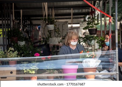 BELGRADE, SERBIA - APRIL 23, 2020: Woman A Merchant On Belgrade Green Farmers Market, Selling Plants And Flowers Wearing Face Mask Protective Equipement On Coronavirus Covid 19 Crisis.

