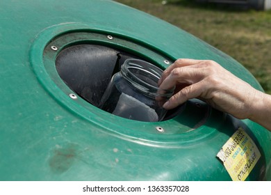 Belgrade, Serbia – April 7, 2019: Woman Putting Glass Jar Into Large Recycling Bin. Eco Friendly. Eco Concept.