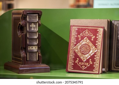 BELGRADE, SERBIA - AUGUST 12, 2021: Selective blur on a Serbian orthodox christian bible and a muslim islam Quran for sale in belgrade,Balkans, where there is a lot of religious cohabitation. 