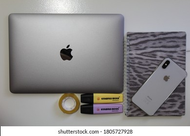 BELGRADE ,SERBIA -AUGUST 31, 2020: Apple Mac Laptop And Apple Iphone Xs Next To Stabilo Highlighter And Candle, Late Night Learning:back To School