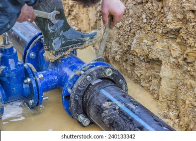BELGRADE, SERBIA - DECEMBER 23: Close up of installing water pipe valve in a trench. Laying a water pipeline, working on water valves. Selective focus. At construction site in December 2014. 