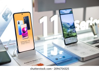 Belgrade, Serbia - December 24, 2021: New Redmi Note 10S Mobile Smartphone Is Shown On Retail Display In Electronic Store. Xiaomi 11 Series Logo In The Background.