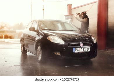 Belgrade, Serbia - December 31 2019 : Man Washing Fiat Bravo Car. Car Wash Isolated.