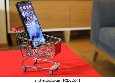 BELGRADE ,SERBIA - JANUARY 08, 2018: Newest Smartphone Iphone X or another name 10, ten in small shopping cart