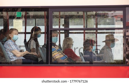 Belgrade, Serbia - July 16, 2020: People Wearing Surgical Face Masks While  Sitting And Riding In A Window Seat Of A Moving Bus, From Outside