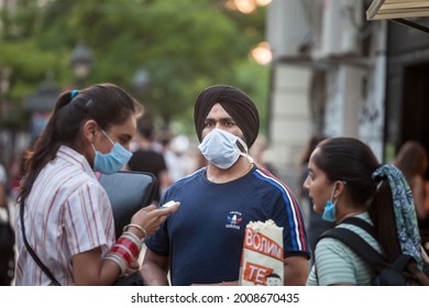 BELGRADE, SERBIA - JULY 6, 2021: Indian Tourists, A Sikh Male Man With Its Distinctive Turban From India, Standing In A Belgrade Street Wearing Face Mask Equipment On Coronavirus Covid 19 Crisis.


