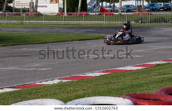 Belgrade, Serbia -\
June 15, 2016: Go kart racer on a track driving towards the finish\
line and for the\
victory