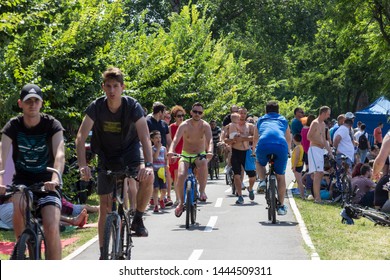 Belgrade, Serbia - June 30, 2019: Busy Day On Ada Ciganlija, Popular Outdoor Area In Belgrade, On A Hot Summer Day. People Cycling By The Lake.