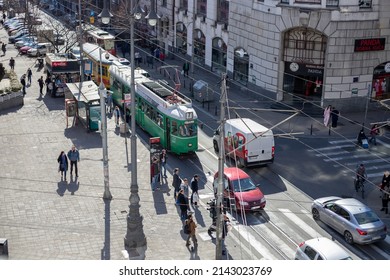 Belgrade, Serbia - March 23rd 2020 :View Of The Intersection In The City. People, Cars And Green Tram Number 7. Belgrade, Serbia.