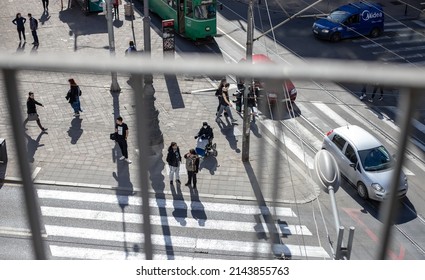 Belgrade, Serbia - March 23rd 2022: Top View Of The Intersection. People Are Waiting To Cross The Street As Well As Women In Wheelchair. 