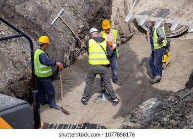 BELGRADE, SERBIA - MARCH 31, 2018: Field engineer using lightweight deflectometer and measuring subgrade and subbase layers percents of compaction of trench bed for new pipeline construction.