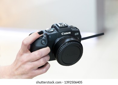 Belgrade, Serbia - May 08, 2019: New Canon EOS RP Mirrorless Camera Is Displayed In Hand With Fully Articulating Screen Isolated On White Background.