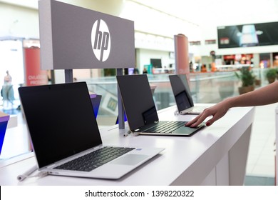 Belgrade, Serbia - May 08, 2019: New HP Laptop Computers With Blank Screen Are Displayed On White Table In Electronic Store. Brand Logo In The Background.