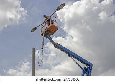 BELGRADE, SERBIA - MAY 10: Worker During Installation Of Metal Pole With Street Lamp, Street Light. Selective Focus. Working On A Street Reconstruction Project In May 2015.