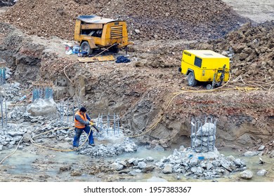 BELGRADE, SERBIA - NOVEMBER 16, 2020: Worker Using Hydraulic Rock Cutter Concrete Pile Breaking Machine.